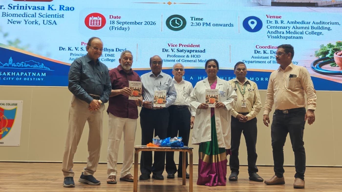 Dr. Rao on stage at Andhra Medical College at the release of his book, standing with the principal of the college and other guests.